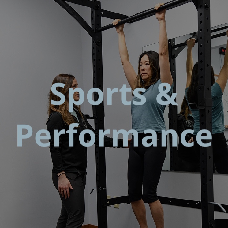 Physical therapist Christina Schicker instructing a patient to hang from a pull up bar.